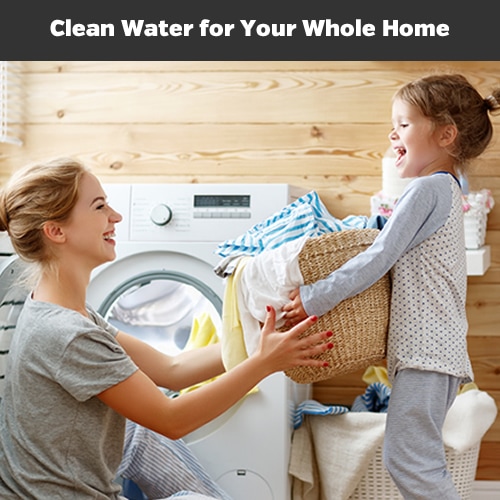 A mom and daughter remove clean, soft laundry from the dryer with the caption that reads, Clean Water for Your Entire Home.