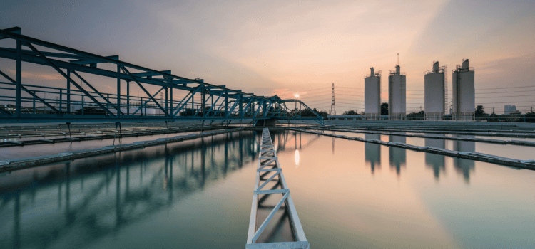 An image that shows a water treatment facility. Typically municipalities add chlorine or chloramine to water to disinfect it.