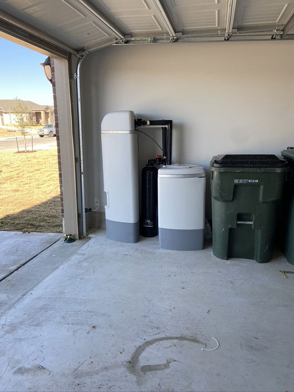 A Pro Elite water softener installed in a home garage.