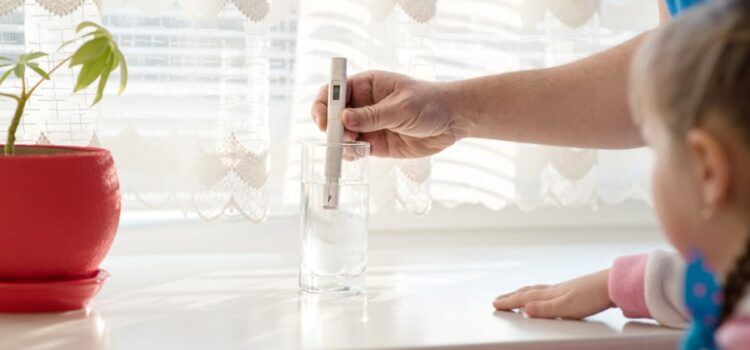 Man checks purity level tap water using water tds meter