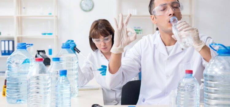 Testing water quality for Cypress water softeners in a lab with multiple bottles.