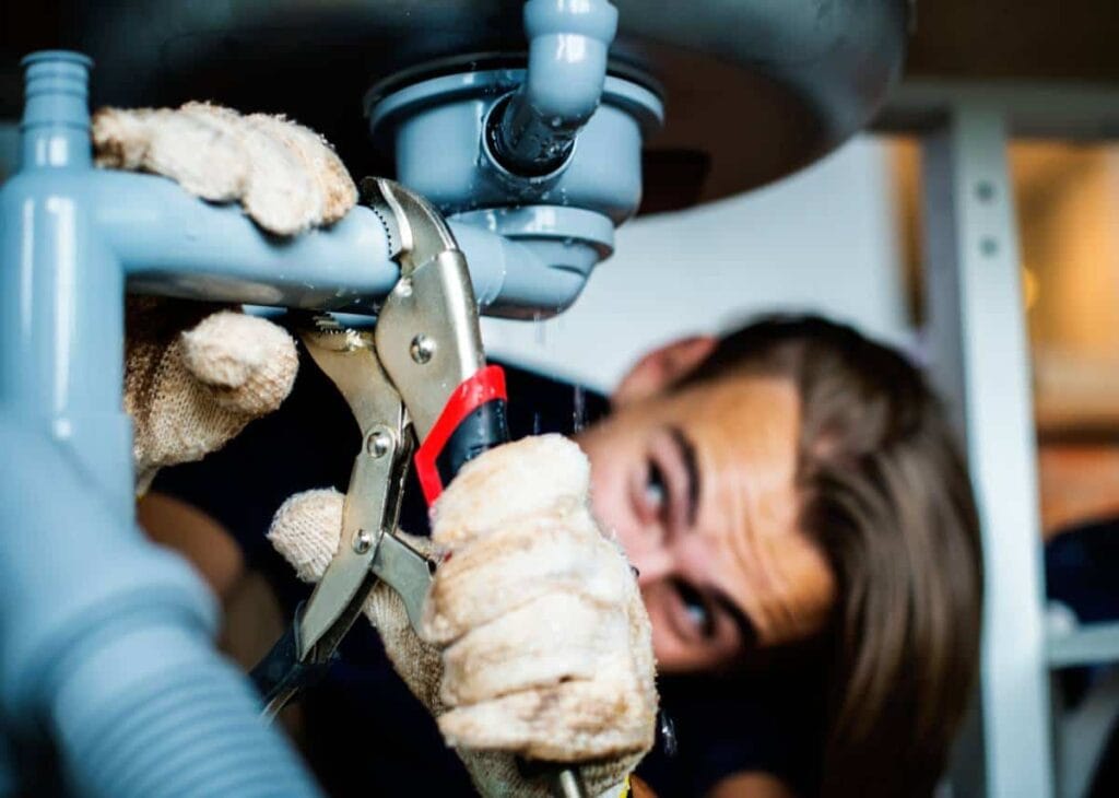 A technician performing repairs on a system for water treatment in Katy TX.