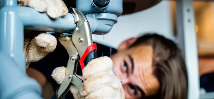 A technician performing repairs on a system for water treatment in Katy TX.