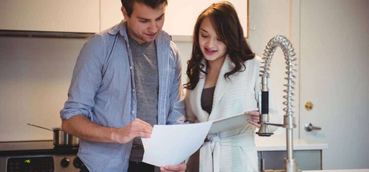A couple discussing Pasadena water softeners and water treatment options in their kitchen.