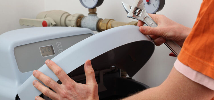 A technician from one of the leading water softener companies in The Woodlands performing maintenance.