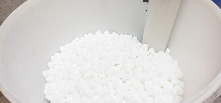 A water softener's salt container is shown, filled with salt.